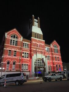 Lighted buildings around City Square Park in Oskaloosa, Iowa