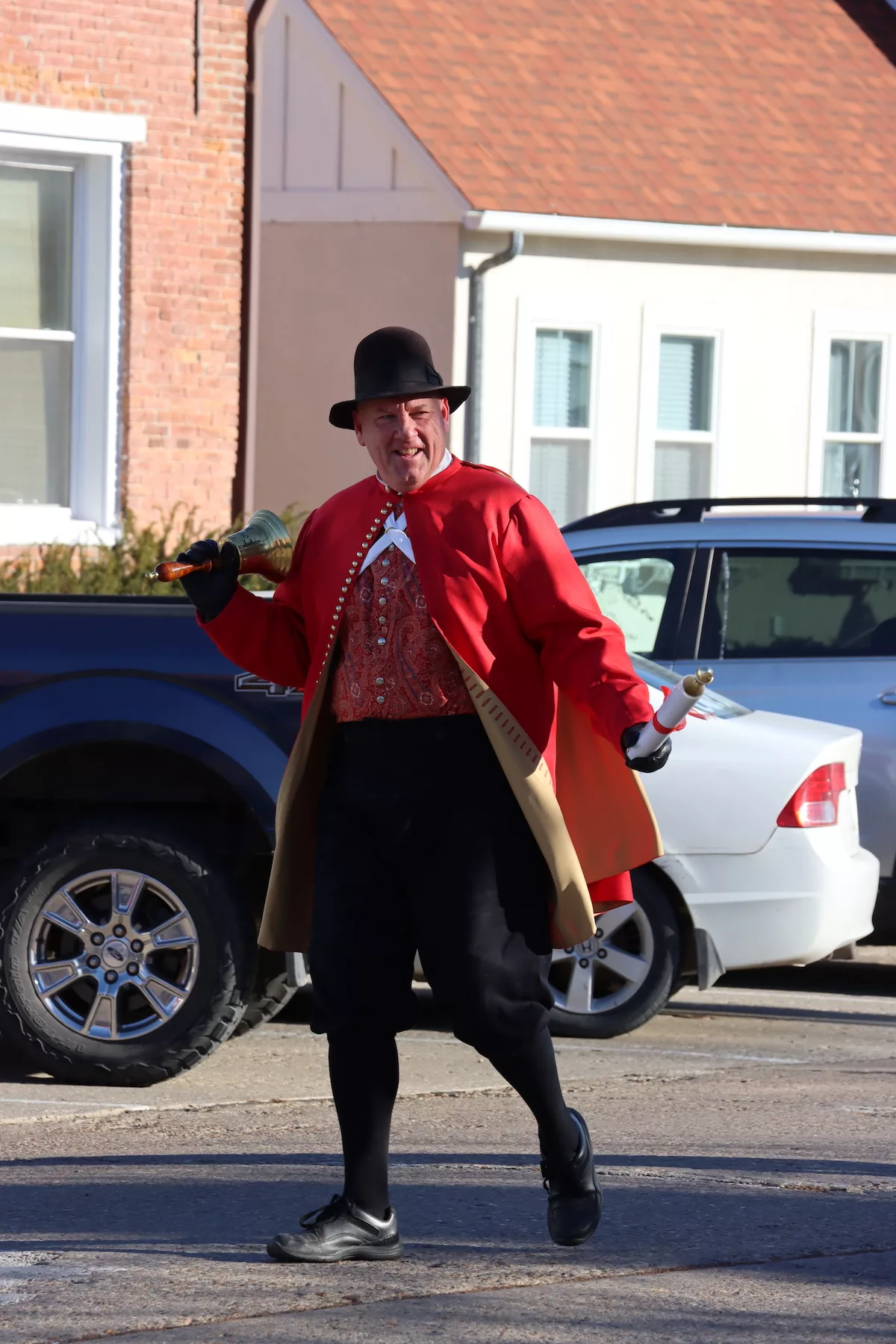 Town crier ringing a bell during parade at Christmas in Pella, Iowa