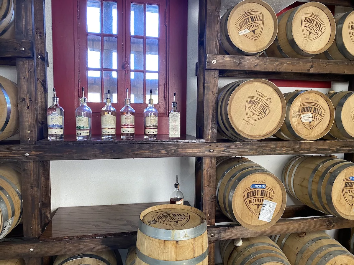 Wall of barrels and sample bottles at Boot Hill Distillery in Dodge City, Kansas
