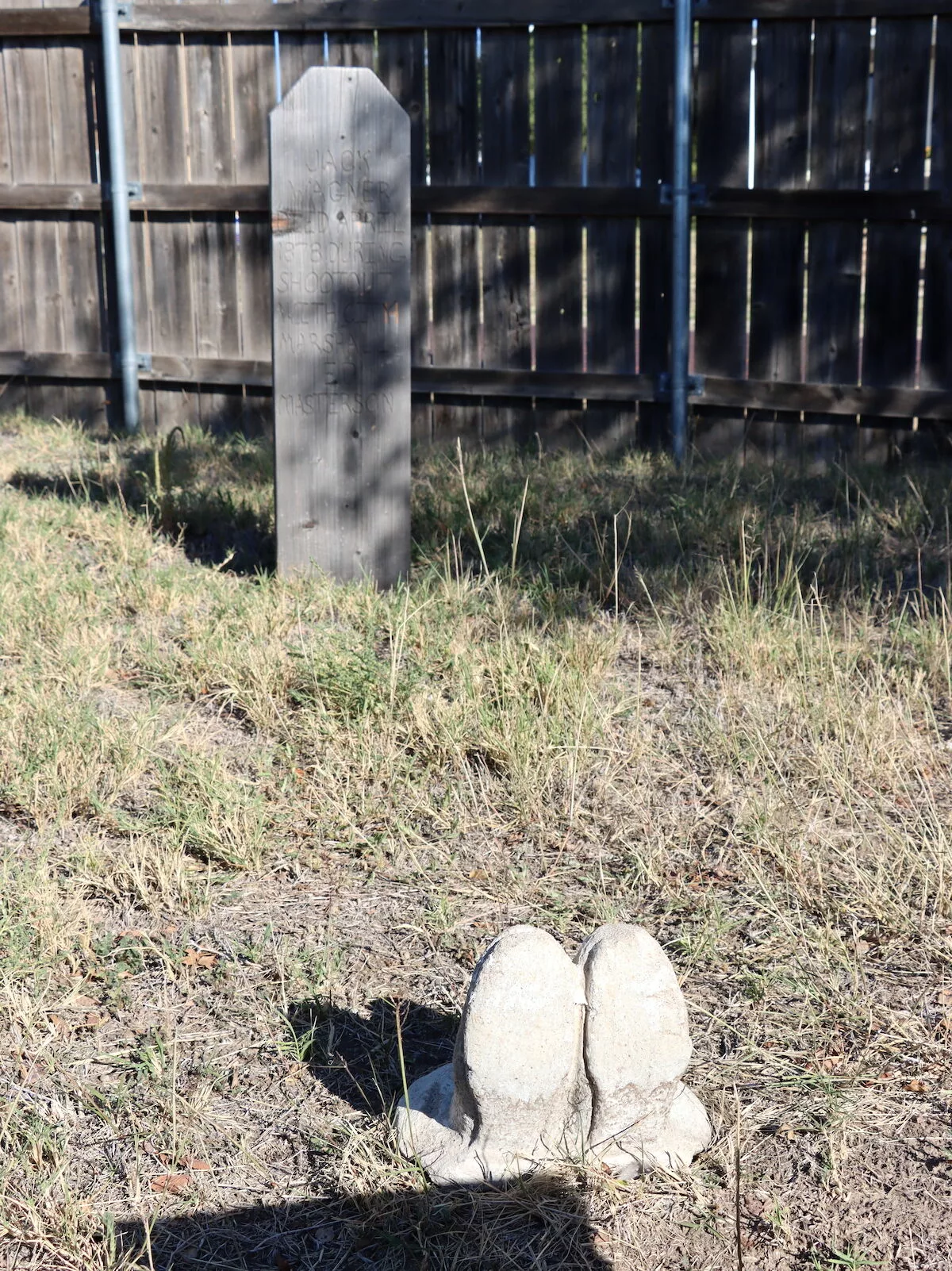 Replica boots in the ground at Boot Hill Cemetery at the Boot Hill Museum in Dodge City, Kansas