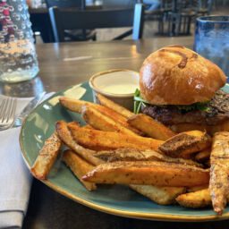 Burger and French fries on a plate at Eclectic Bistro in Dodge City, Kansas