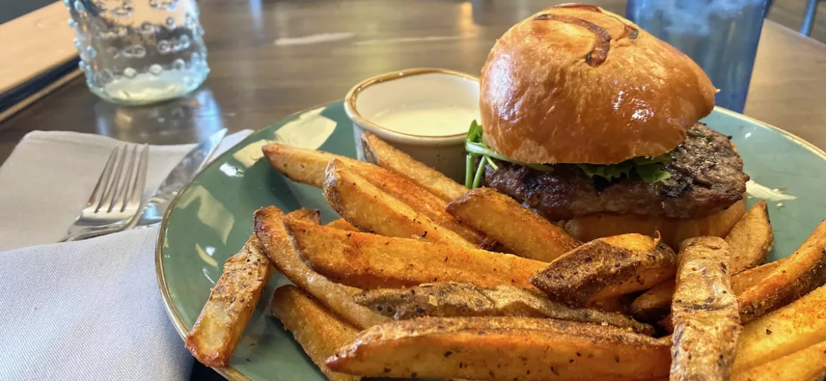 Burger and French fries on a plate at Eclectic Bistro in Dodge City, Kansas