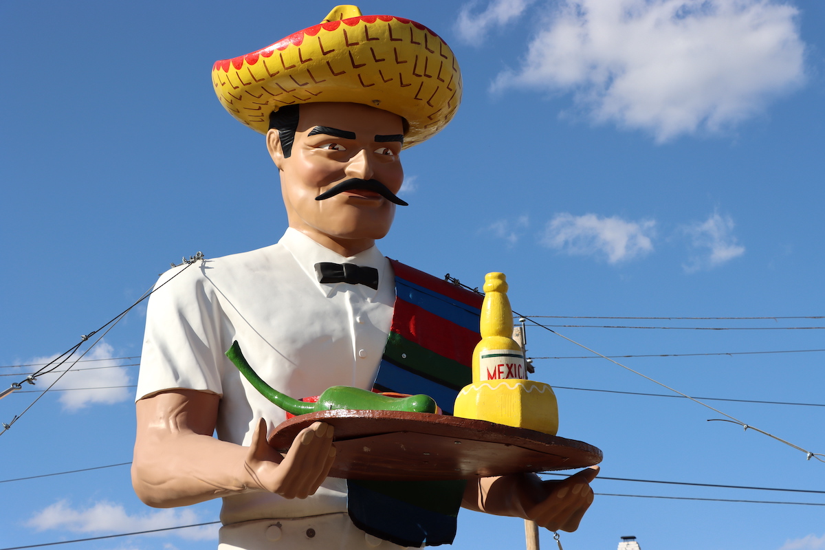 La Salsa Man Muffler Man holding tray with food and wearing sombrero in Dodge City, Kansas