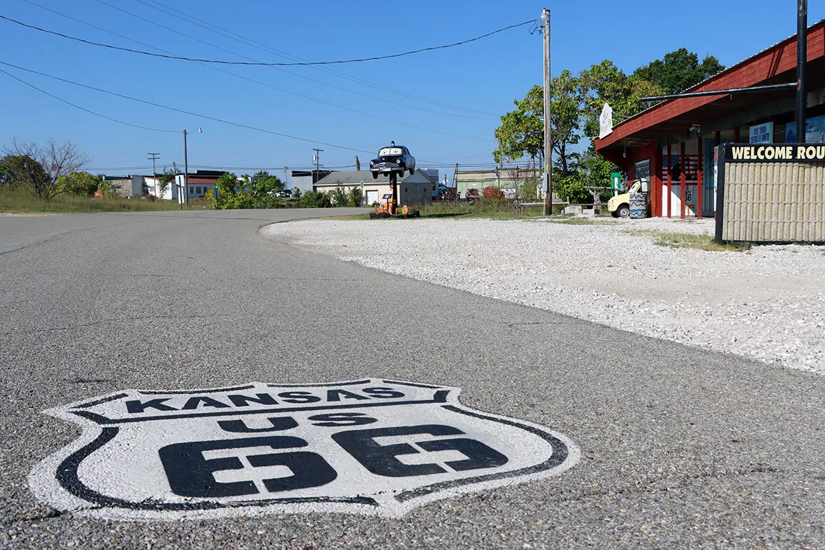 Kansas Route 66 medallion painted on road in front of Luigi's Pit Stop in Galena, Kansas