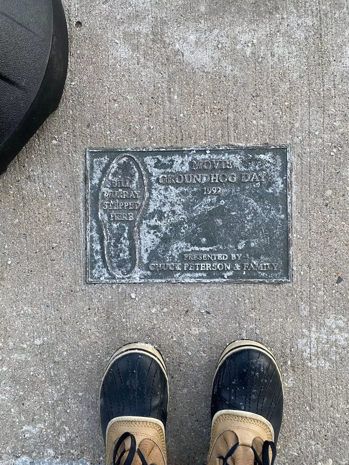 Plaque marking where Bill Murray stepped in Groundhog Day in Woodstock, Illinois