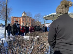 Group of people on walking tour of Groundhog Day filming locations in Woodstock, Illinois