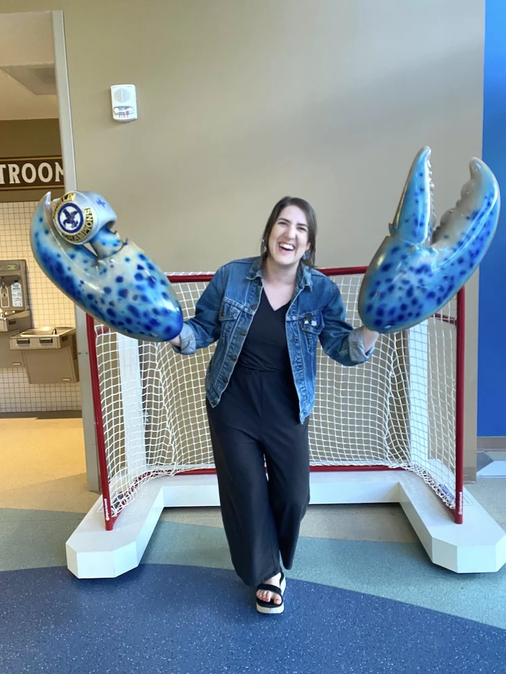Woman posing with hands inside blue lobster claws with a Stanley Cup ring on them at the St. Louis Aquarium at Union Station in St. Louis, Missouri