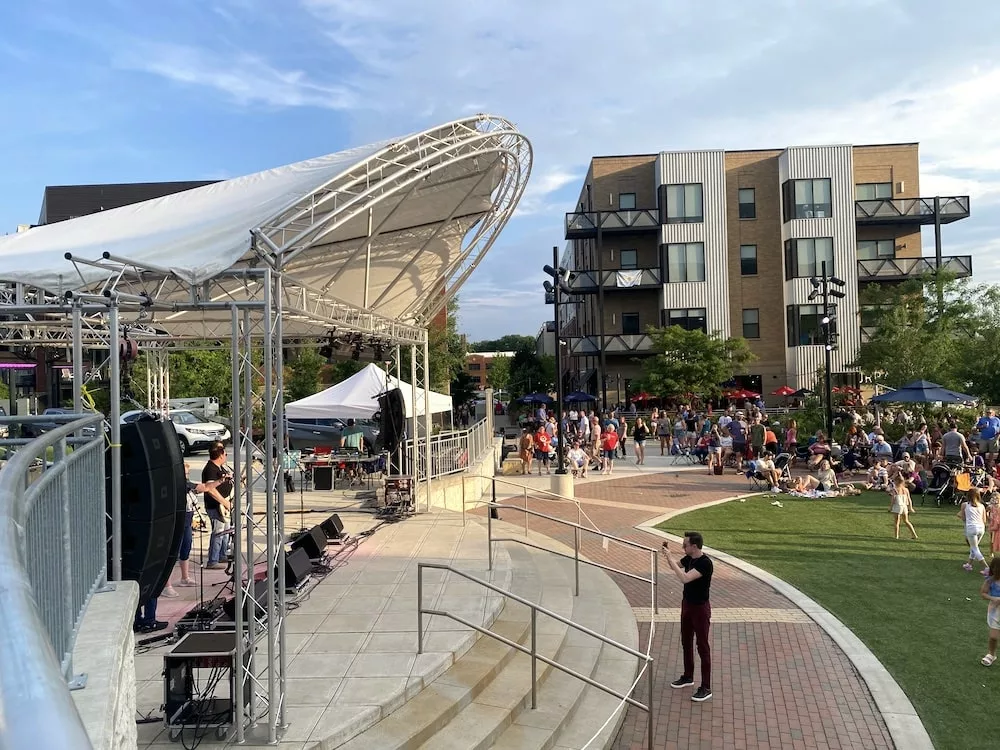Crowd of people at River Place Plaza for the Live to 9 summer concert series in Cedar Falls, Iowa