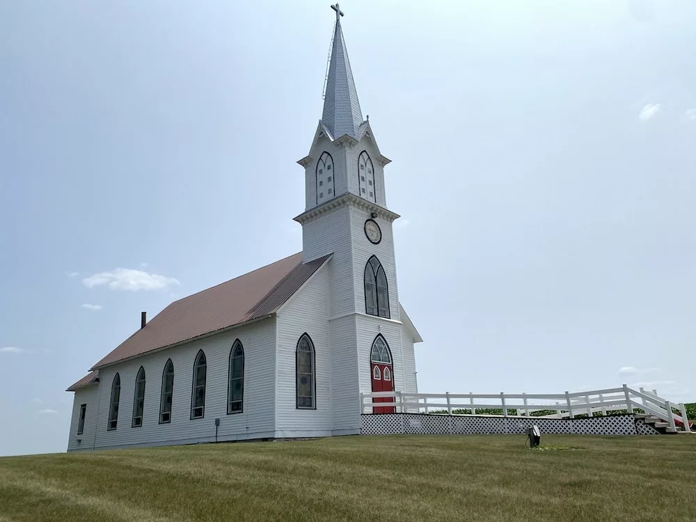 Historic church with steeple at Manning Hausbarn Heritage Park in Manning, Iowa