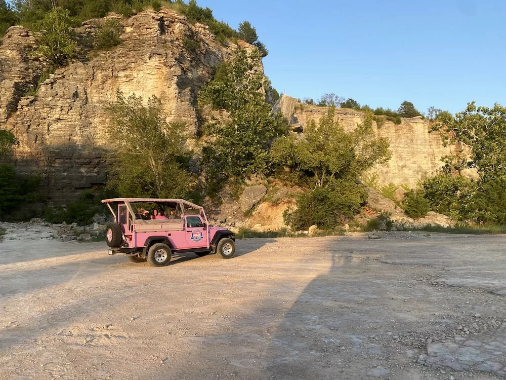 Pink Jeep in the basin of a former quarry during the off-roading experience on a Pink Jeep Adventure Tour in Branson, Missouri