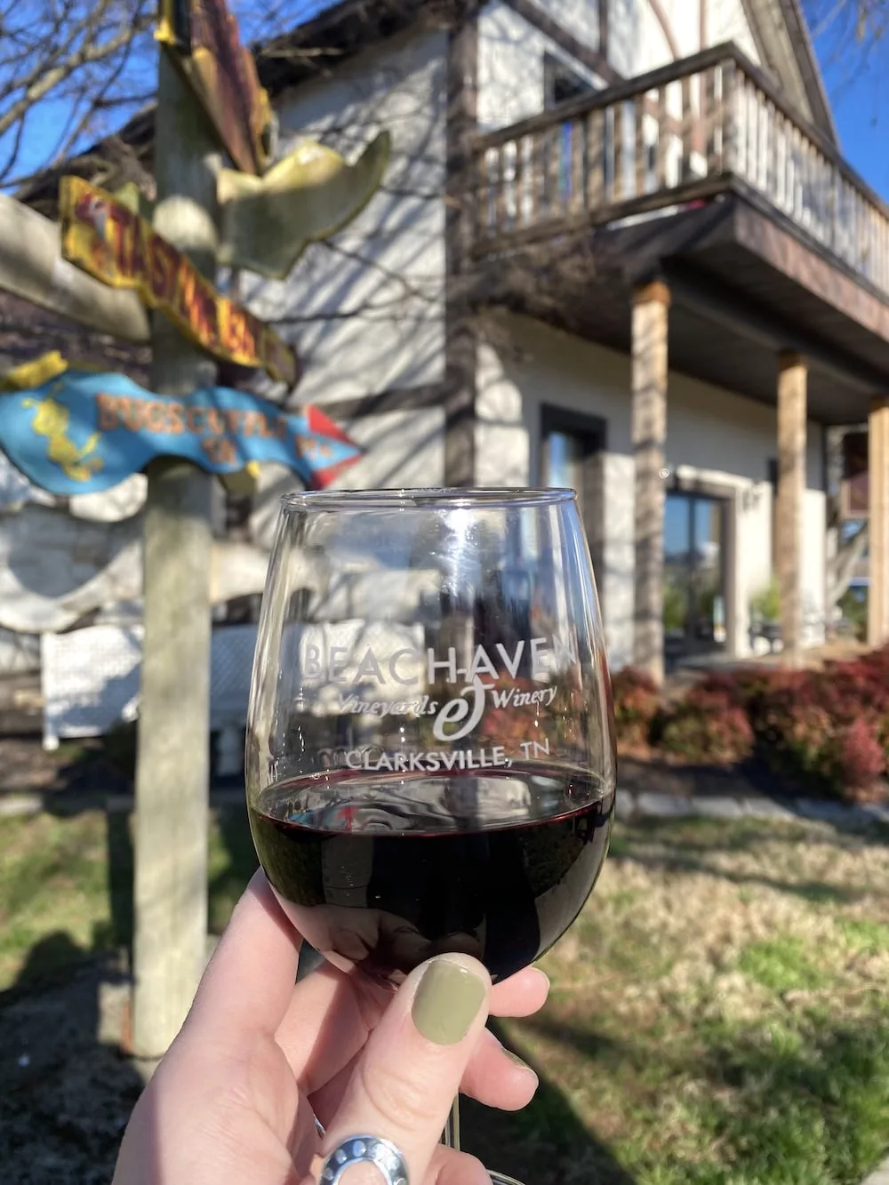 Hand holding glass of wine at Beachaven Winery in Clarksville, Tennessee